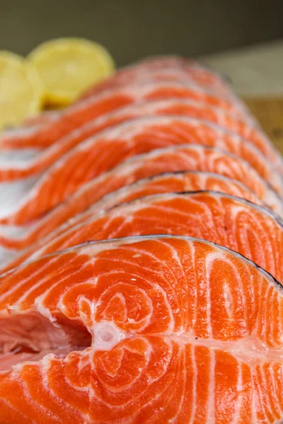 Red fish steak, freshly cut with peel on a cutting board — Stock Image Red Fish Steak Freshly Cut Peel Cutting Board Royalty Free Stock Images