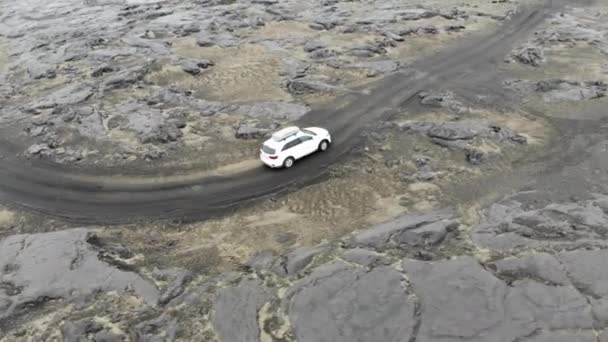 Aerial View Drone Follows White Car Road Lava Fields North — Stock Video