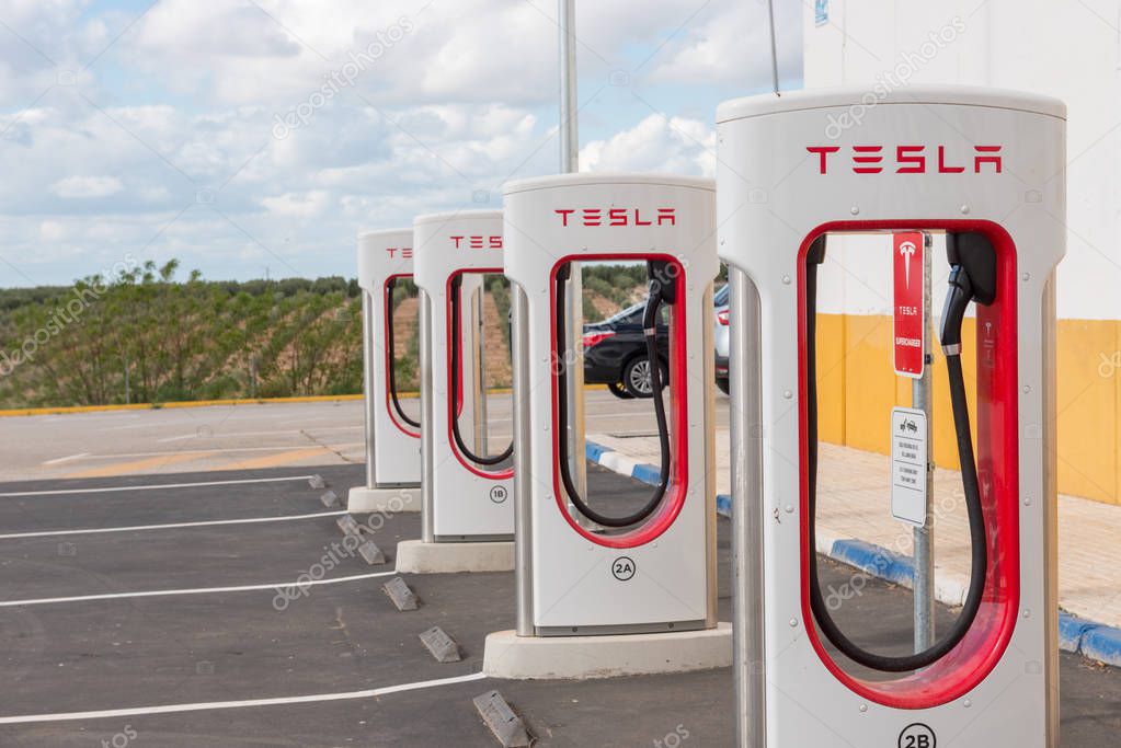 AGUADULCE, SEVILLE, SPAIN - APRIL 29, 2018: A Tesla electric supercharger stand at a gas station in Aguadulce, Seville, Spain