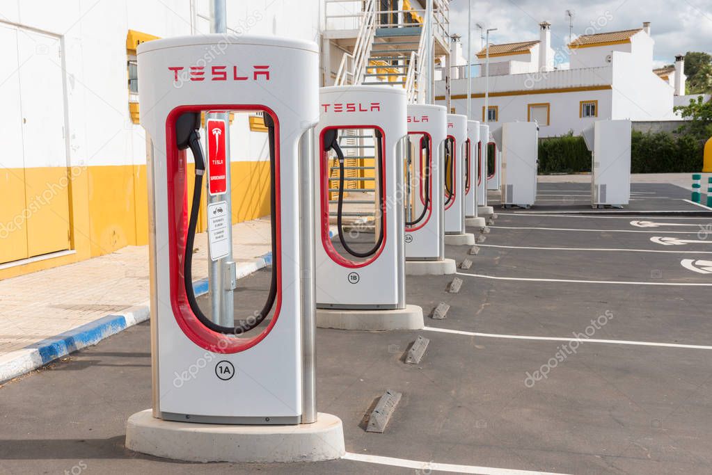 AGUADULCE, SEVILLE, SPAIN - APRIL 29, 2018: A Tesla electric supercharger stand at a gas station in Aguadulce, Seville, Spain
