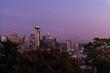 Seattle şehir silüeti ve arka planda Mount Rainier profili üzerinde günbatımı.