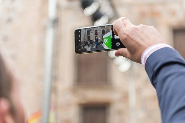 A man takes a photograph of the intervention of the leader of the extreme right-wing Vox party, Santiago Abascal — Stock Photo, Image