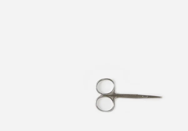 Metallic silver manicure sharp scissors on a white background — Stock Photo, Image