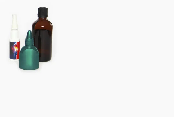 multi-colored medical containers, jar and spray for medicine on a white background