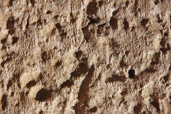 Brown stone or mwith cracks and patternsarble wall a texture — Stock Photo, Image