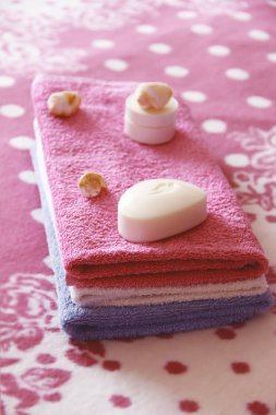 pembe havlu arka planına karşı beyaz tuvalet sabun ve dekor