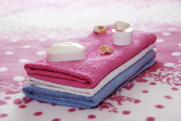 pembe havlu arka planına karşı beyaz tuvalet sabun ve dekor