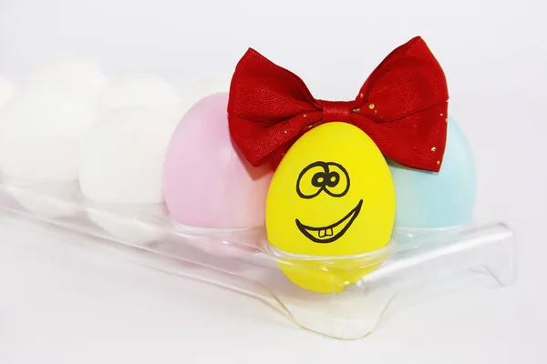 Žluté dekorativní veselé kuřecí vejce s očima a úsměvem na svátek svatých Velikonoc — Stock fotografie