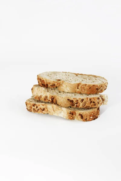 Pieces of rye bread with seeds on white background — Stock Photo, Image