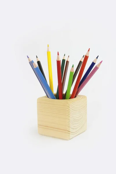 Colorful pencils for drawing in a wooden cube — Stock Photo, Image