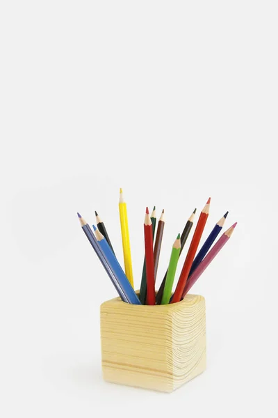 Colorful pencils for drawing in a wooden cube — Stock Photo, Image