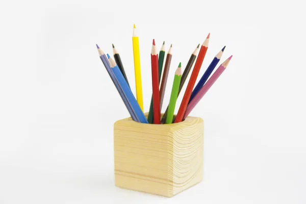 Colorful pencils for drawing in a wooden cube — Stock Photo, Image