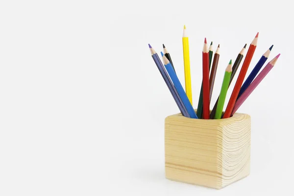 Colorful pencils for drawing in a wooden cube — Stock Photo, Image