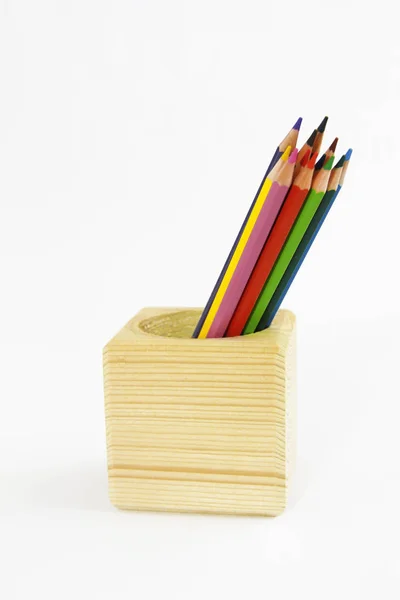 Colorful pencils for drawing in a wooden cube Royalty Free Stock Photos