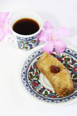 Renkli plaka üzerinde Doğu Türk geleneksel tatlı baklava ve bir fincan kahve