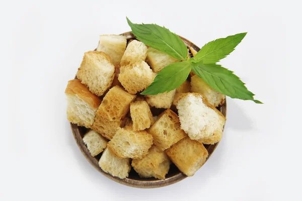 Fried white bread croutons with mint leaves in wooden plate — Stock Image Fried white bread croutons with mint leaves in wooden plate Royalty Free Stock Images