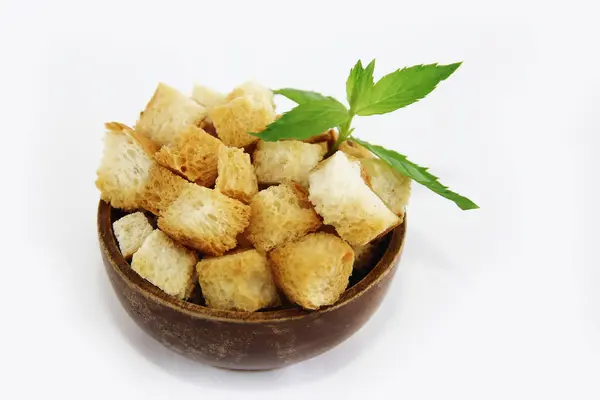 Fried white bread croutons with mint leaves in wooden plate — Stock Image Fried white bread croutons with mint leaves in wooden plate Royalty Free Stock Photos