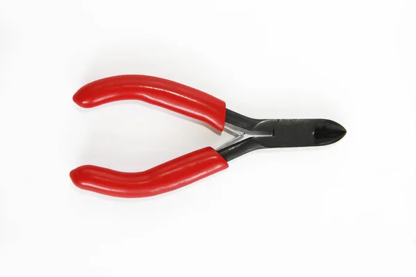 Old rusty pliers tools, metal cutting pliers with red handle — Stock Photo, Image