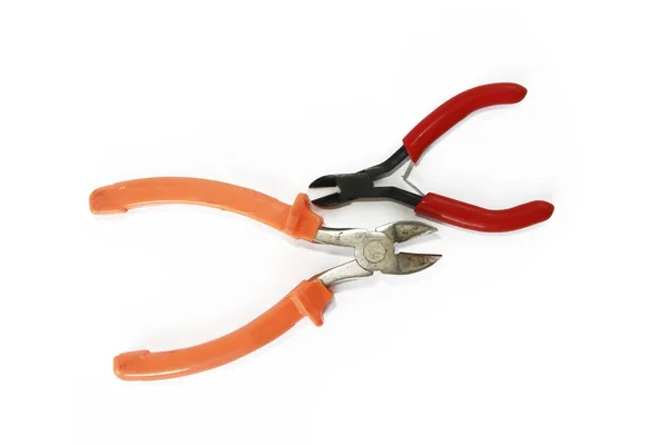 Two metal old rusty pliers with red and orange handle — Stock Photo, Image