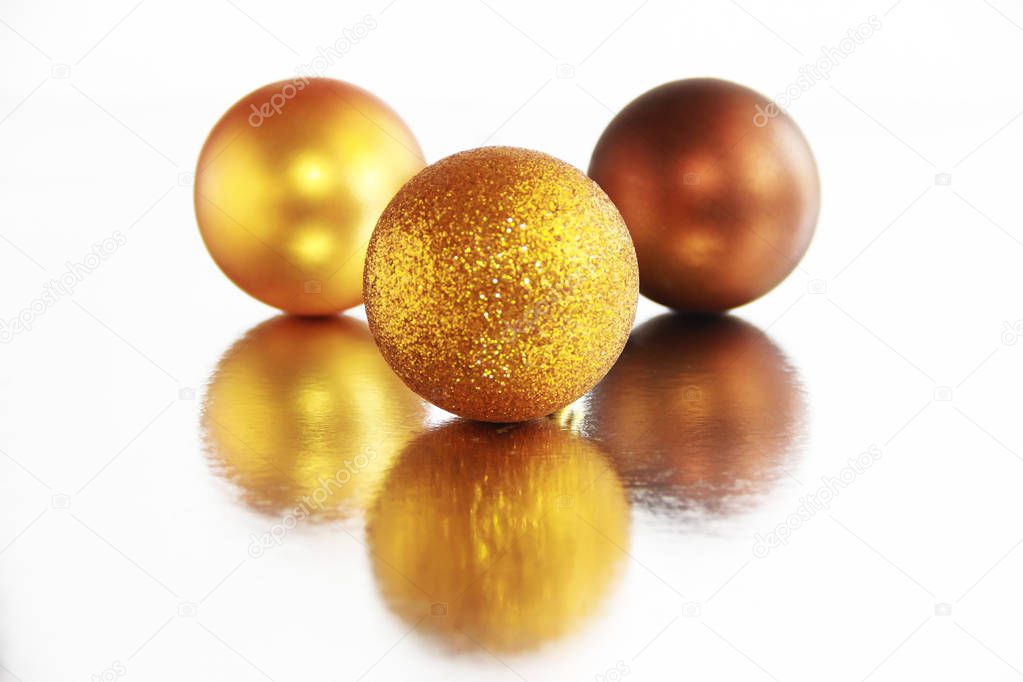 orange shiny christmas toys balls on a mirror background with reflection