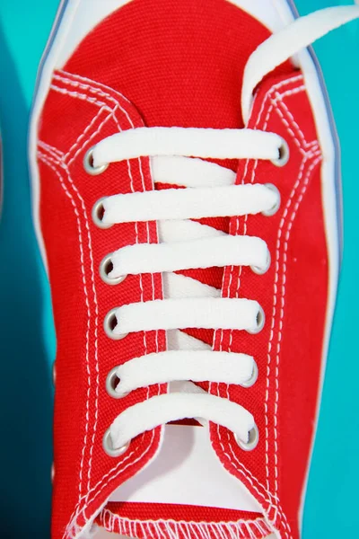 red athletic shoes sneakers with white laces