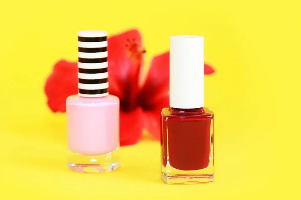 red and pink nail Polish in glass a bottles
