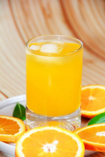 orange drink in glass and round orange slices