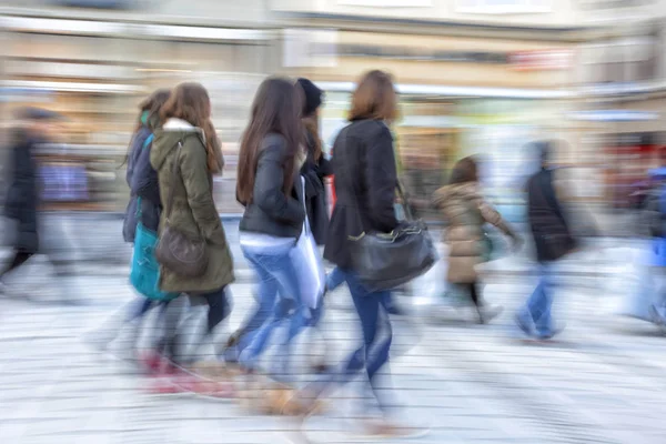 Large group of busy people in motion blur