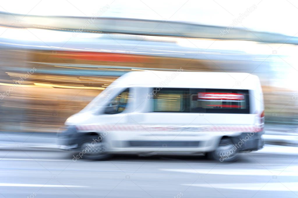 White car driving fast in the city, motion blur