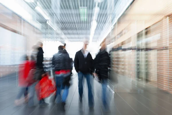 Large group of real people walking indoors, shopping spree — Stock Photo, Image