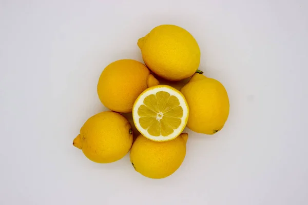 Many lemons and a half of a lemon isolated image on a white back — Stock Photo, Image