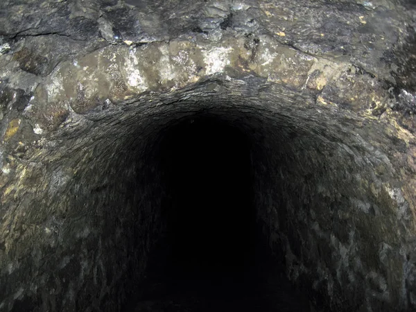 The stone arches corridor of the mysterious tunnel underpasse — Stock Photo, Image