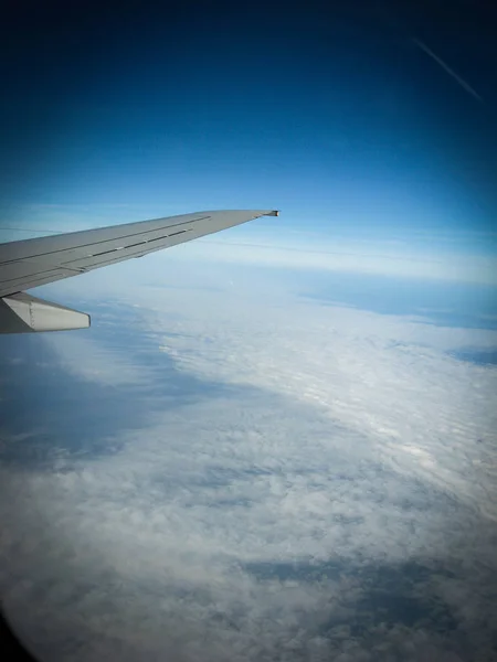 View from the airplane porthole on white clouds. The frame also — Stock Photo, Image