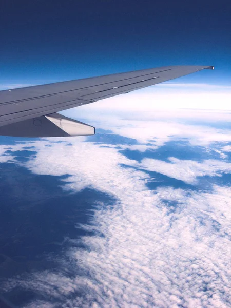 View from the airplane porthole on white clouds. The frame also — Stock Photo, Image