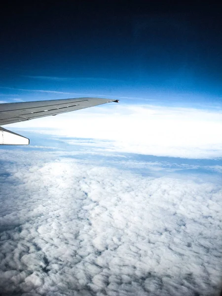 View from the airplane porthole on white clouds. The frame also — Stock Photo, Image