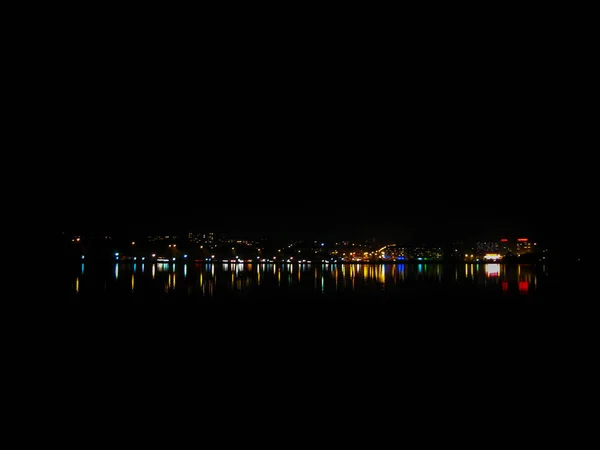 Wonderful night city landscape. Night city lights reflected in t