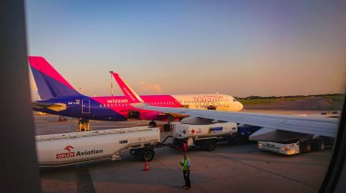 Warsaw, Poland - May 10, 2018: A Moment From The Life Of The Airport. The Wizz Air Aircraft Is Refueling. clipart