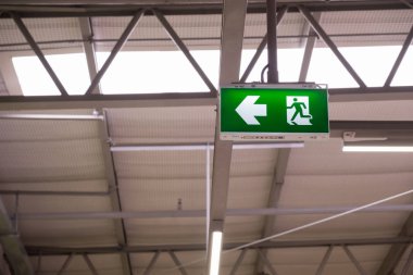 Yangın çıkış ışık işareti. Kaçmak için yol gösteren yeşil acil çıkış işareti
