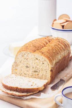 Dilimlenmiş ekmek, tereyağı bıçak ve sütlü kahve