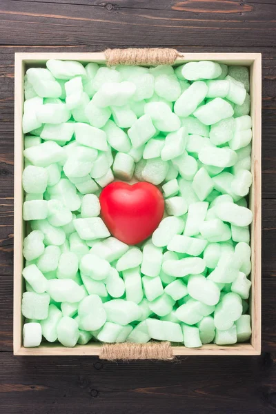 Red heart well protected by soft green material