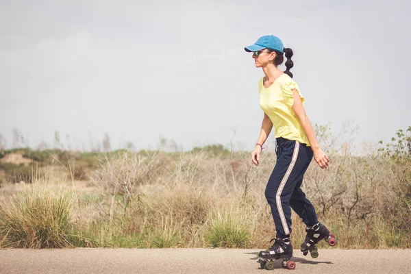 Çölde ıssız bir yolda paten kadın