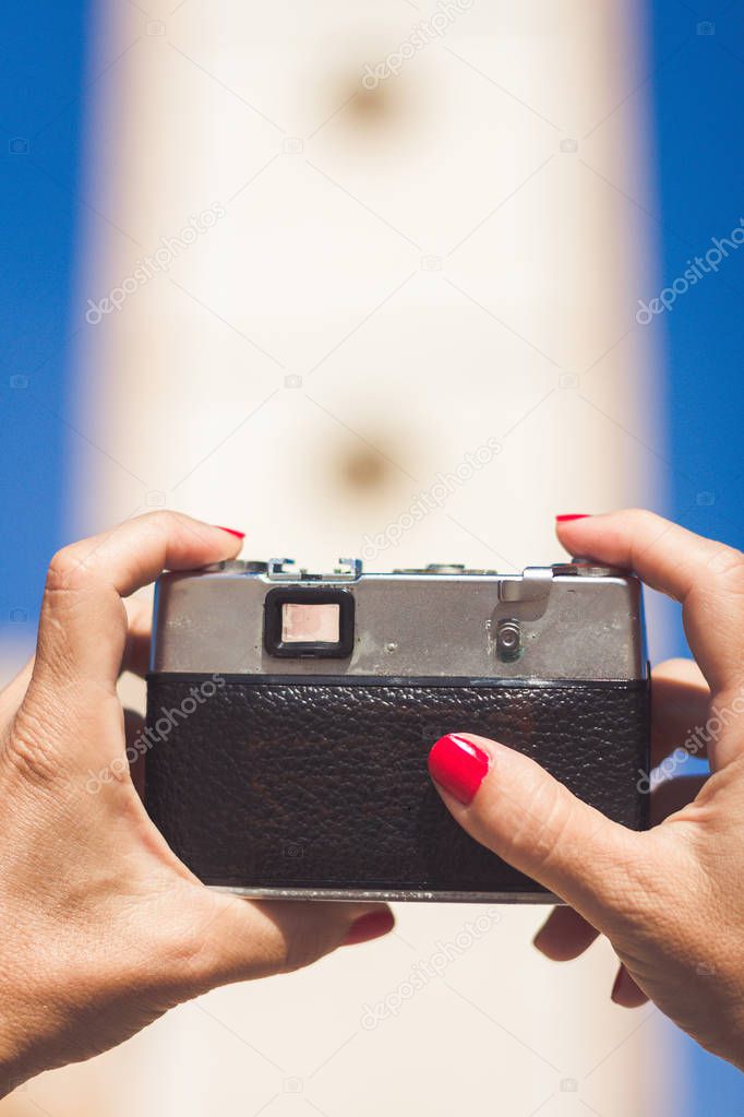 Woman's hands handling an old photography camera