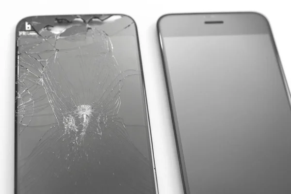 One broken screen and one new phone screen on white background