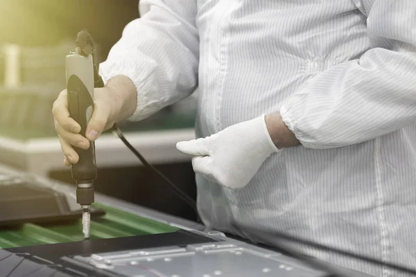 Assembling the TV in the factory in a clean room. Toned