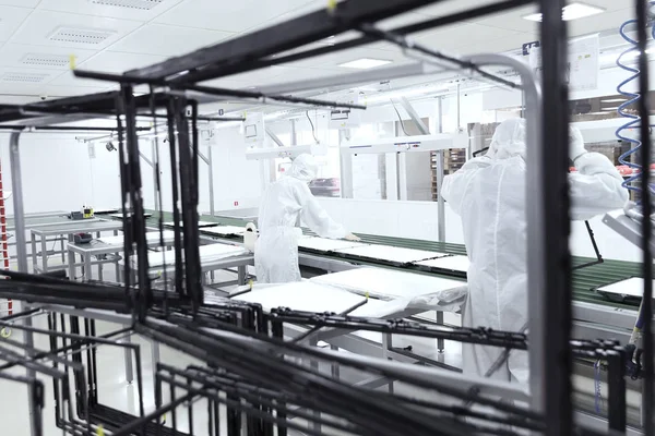The process of assembling TVs in a clean room