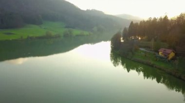 Hava: güzel gölet üzerinde akşam günbatımında sonbaharda uçan. Sakin güneşli hava temiz su yansıtan doğa ile yuvarlak göl.