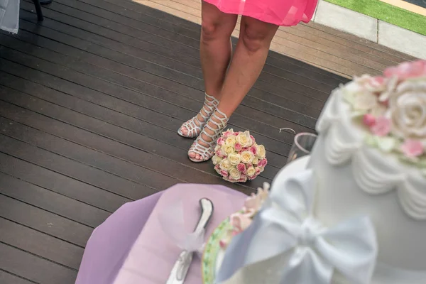 Closeup gelinler ayakkabıları yanında döşeme pembe ve sarı kokulu. Avustralya inanılmaz kum plaj düğün ateş.