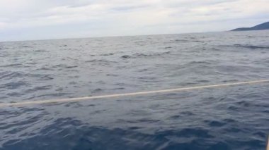 Yelkenli tekne yan çit ile filme. Yelkenli tekne yavaş tarafından geçen karanlık derin mavi deniz hareket hd.