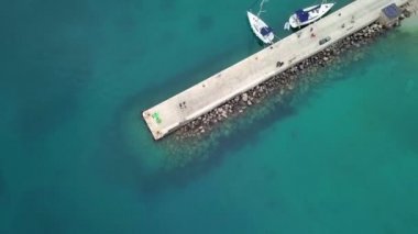 Hava: Park edilmiş Yelkenli tekne ile denizde beton iskele üzerinde uçan. Kuşlar bakış açısından görüntüleme. Hırvatistan Adriyatik denizinde yelken gezisi olarak film.