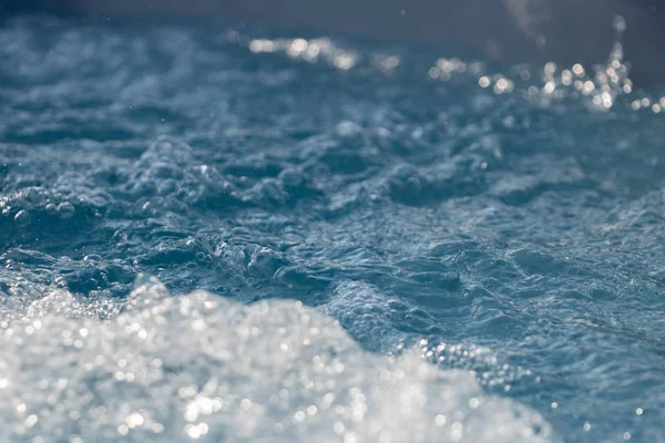 surf of the sea, bubble of air in the water foam in a jacuzzi